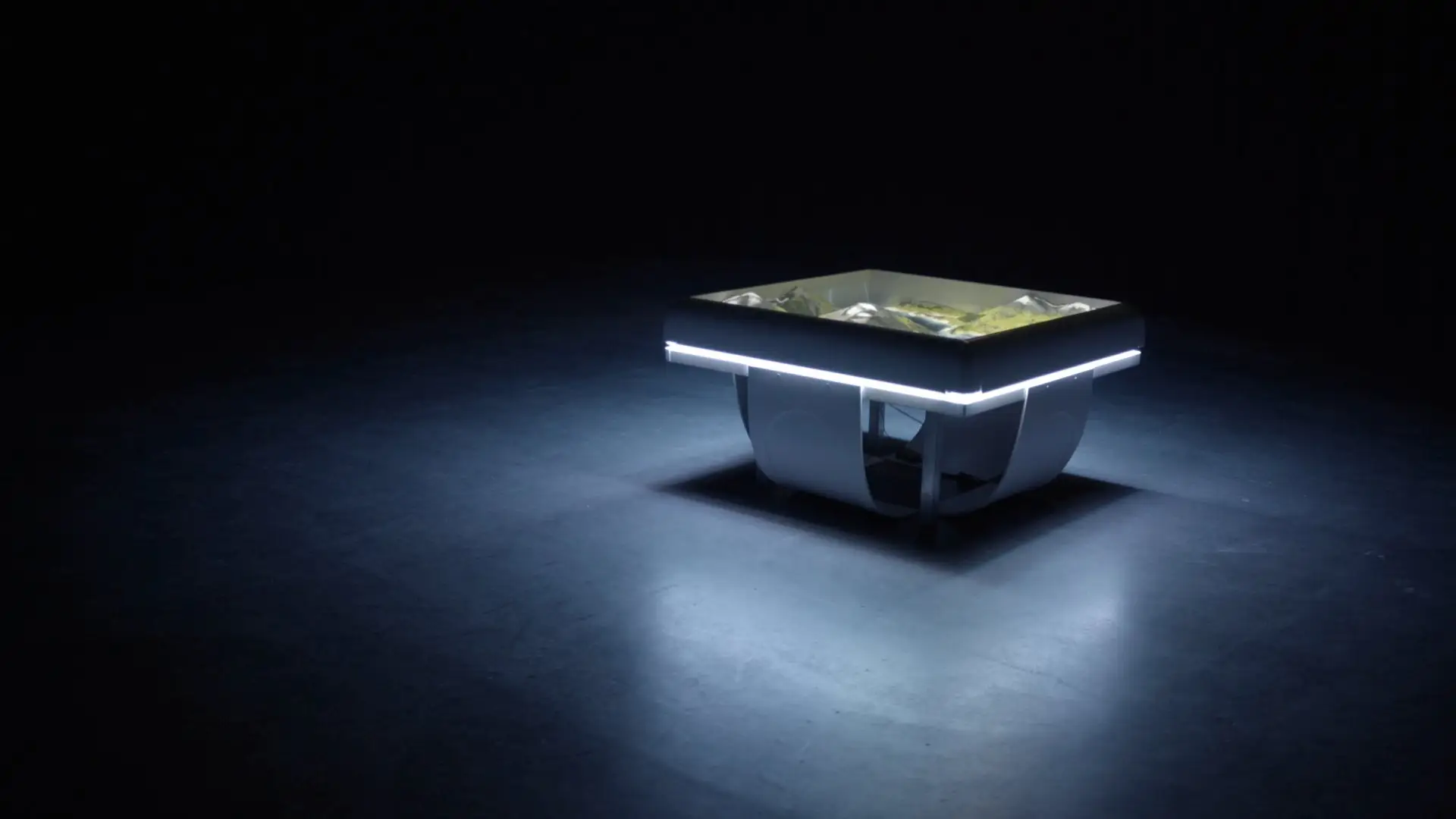 The illuminated sand table alone in a darkened room