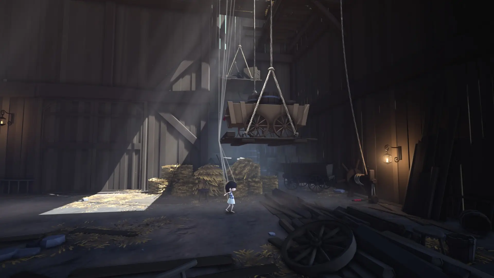 Abby standing in a shaft of light inside a timber mill, a hoist overhead