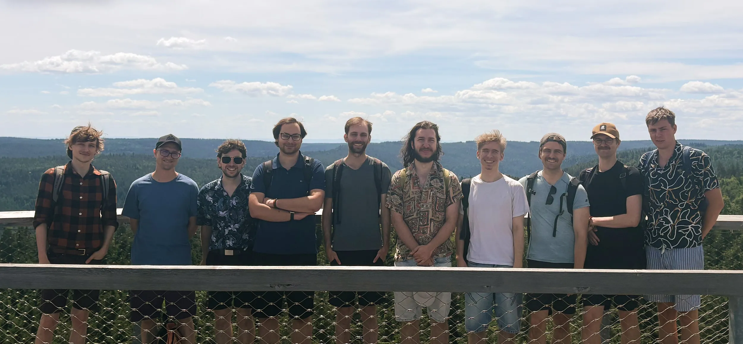The kaleidoscube team on a viewing platform above a forest